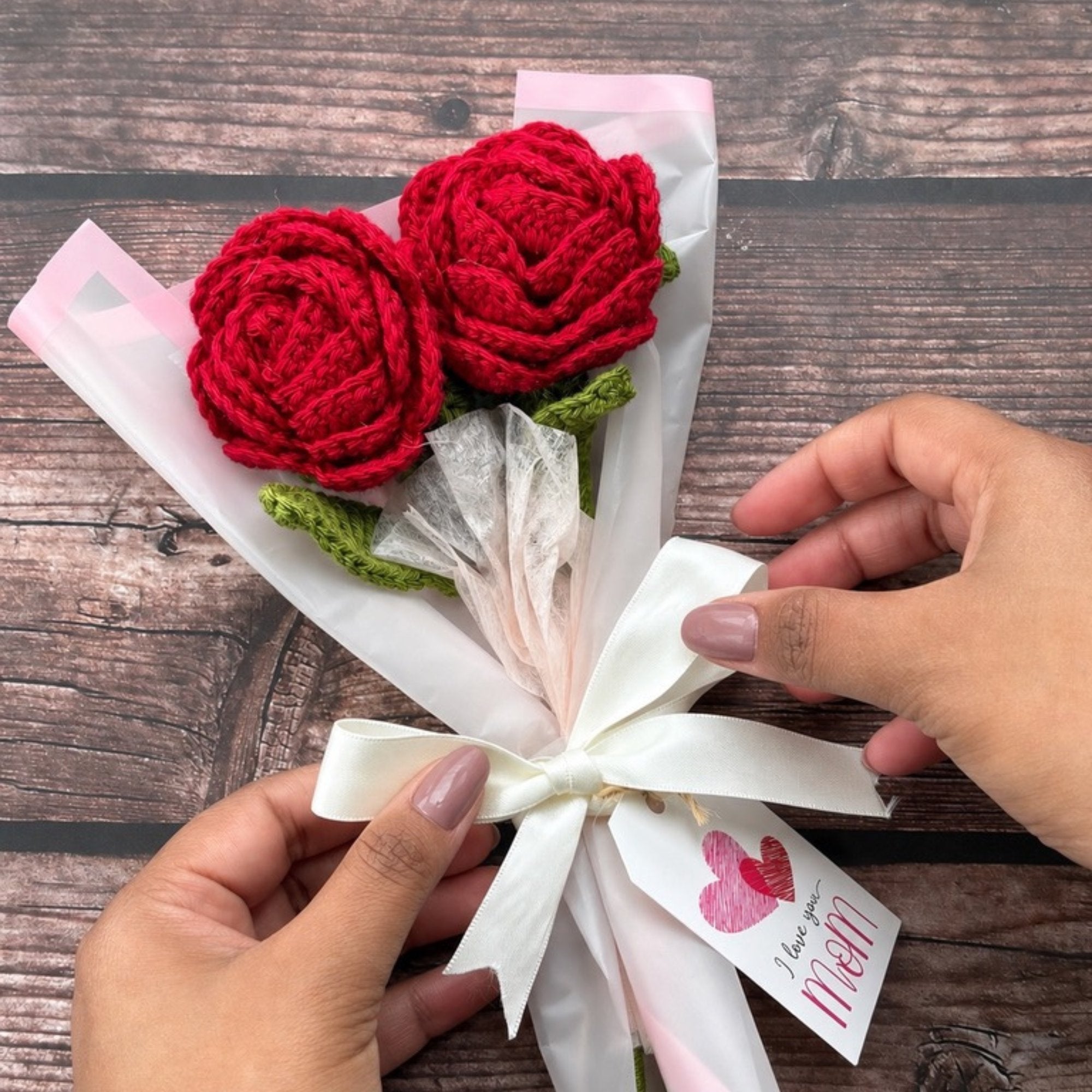 Crochet two-rose bouquet held in hand, handmade gift from Toronto