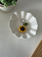 Crochet sunflower keychain flatlay, handmade in Toronto