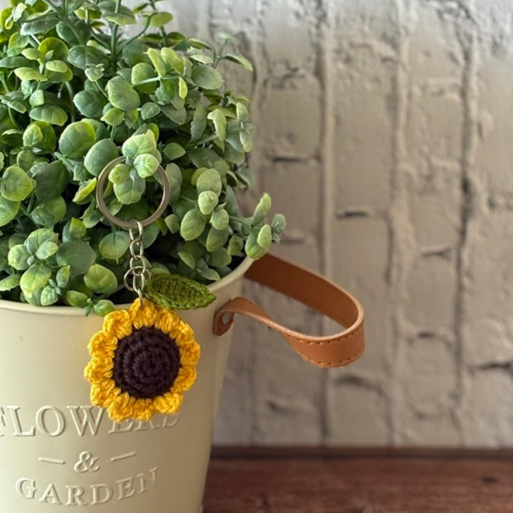 Crochet sunflower keychain lifestyle shot, handmade bag charm from Toronto