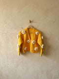 Yellow crochet cardigan with white puff flowers